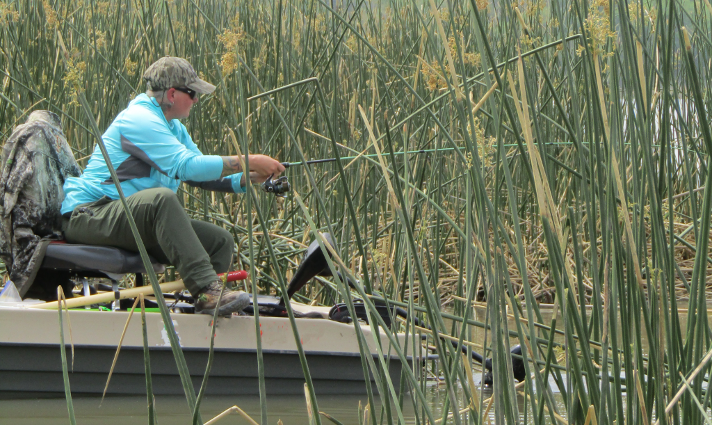 AJ fishing from the Bass Raider 10e